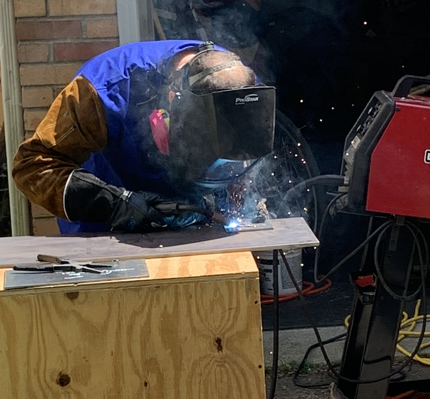 Mark Shalinsky welding in a workshop